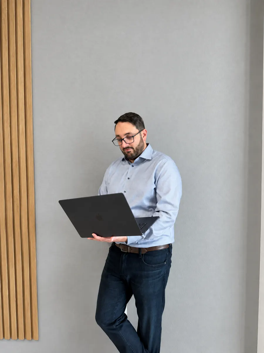 A Tomegan Marketing Group team member working on a laptop